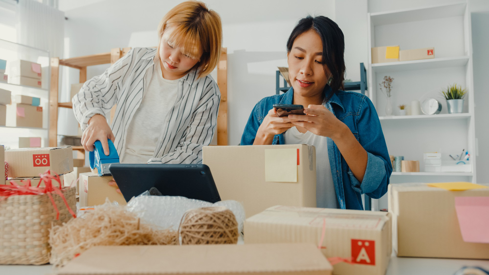 Two women working in a small business packaging and shipping orders. 