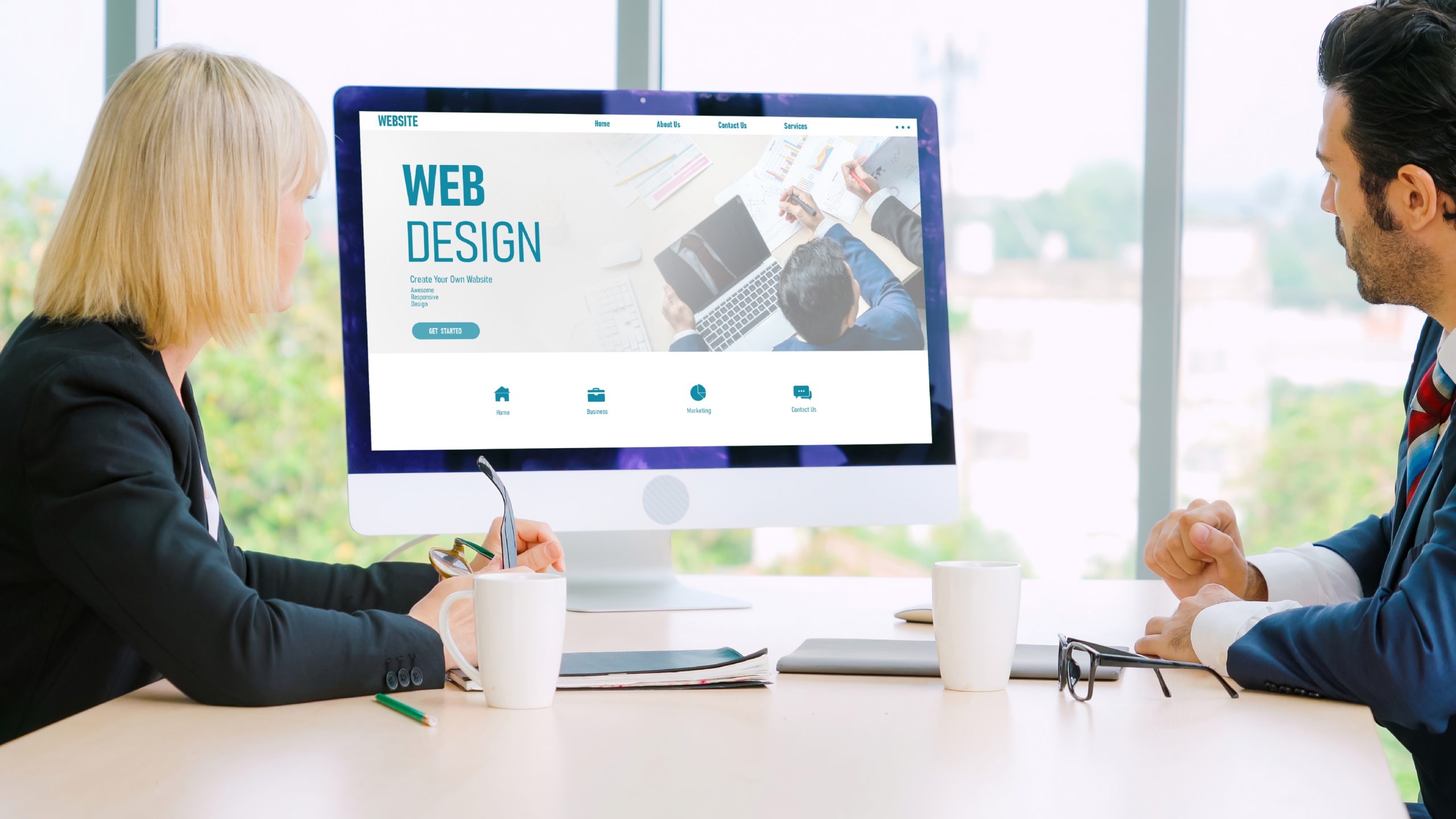 Website design software provide modish template for online retail business - Wholesale Suite Two professionals reviewing a computer screen displaying web design concepts
