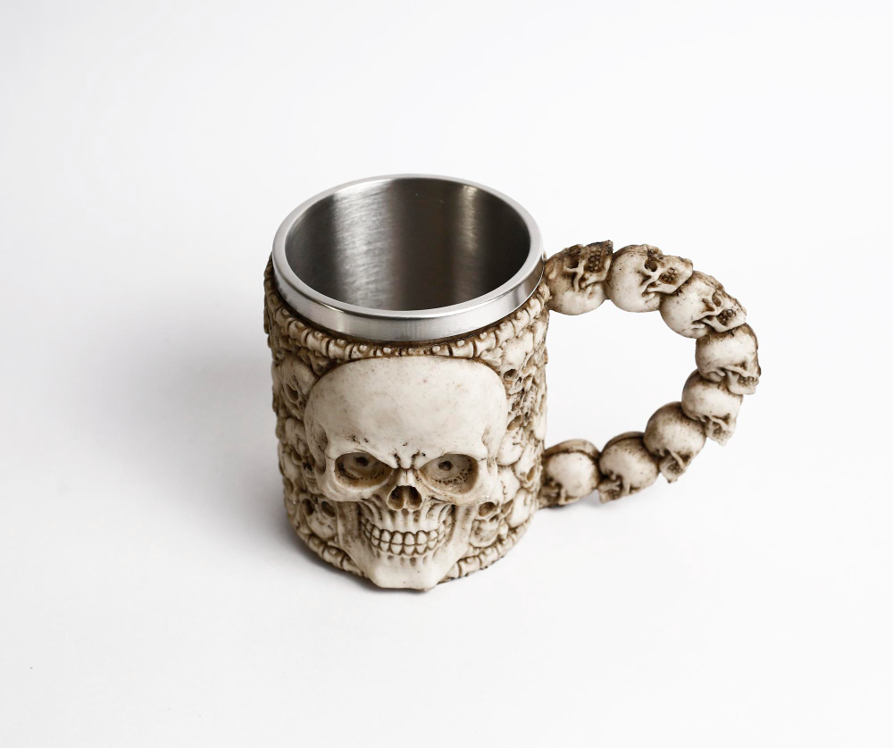 Halloween-themed mug with a skull design and a handle made of miniature skulls